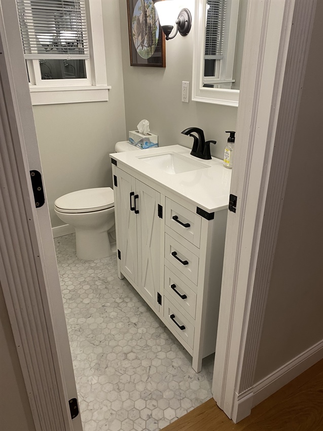 Outdated Minnetonka bathroom before full gut remodel with cramped vanity and limited floor space