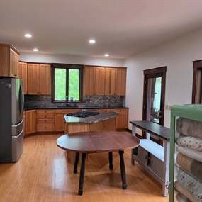 Updated Lake Elmo kitchen with painted walls, recessed lighting, wood cabinets, and stone backsplash