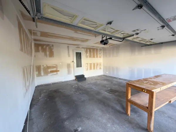 Apple Valley garage walls and ceiling mid-repair with drywall seams coated in mud