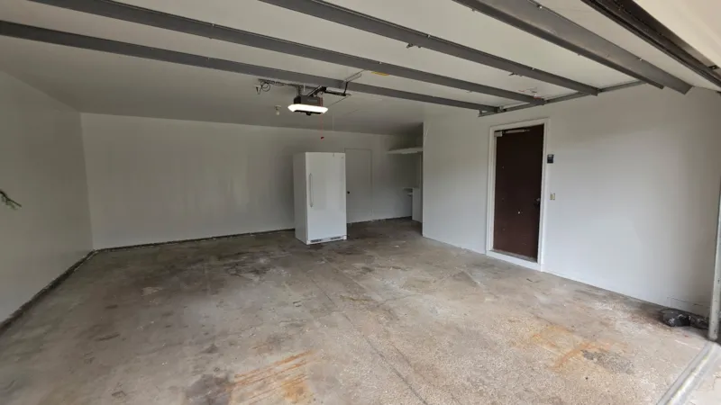 Apple Valley garage back wall finished and painted white after drywall repair