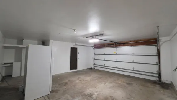Painted Apple Valley garage with finished drywall and a new attic access panel