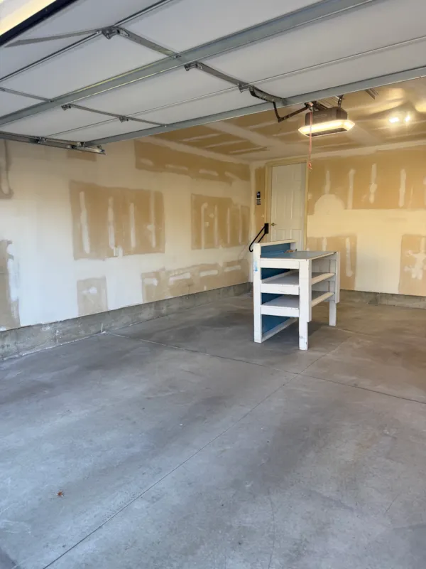 Eagan garage walls with taped and mudded drywall around the man door during repair