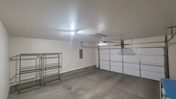 Finished Eagan garage with smooth painted ceiling and walls beside the garage door