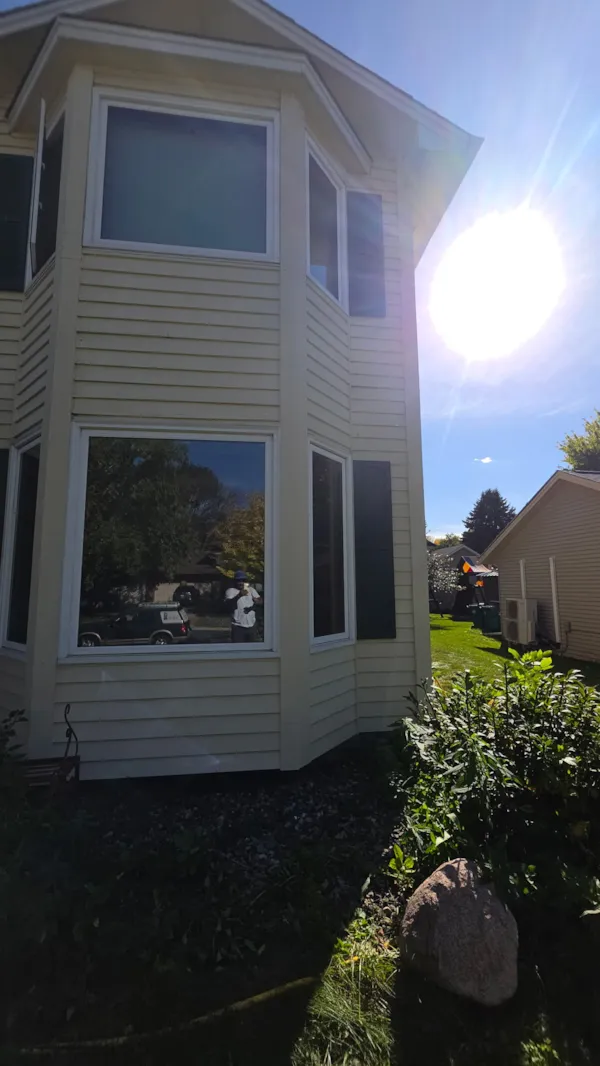 Finished bay window exterior with repaired trim and siding painted to match in Burnsville